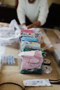 Box filled with sewing fabrics, patterns, and textile supplies