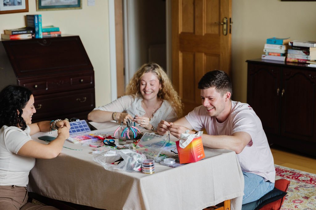 Man and woman sitting on the floor working on creative projects together
